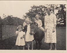 Family at Bell House Rowington.-1 A family at The Bell House The girl on the left is Vivian, her mother Catherine Cooper (married to Henry John Cooper) is on the right. Jean Finley is on Fancy...
